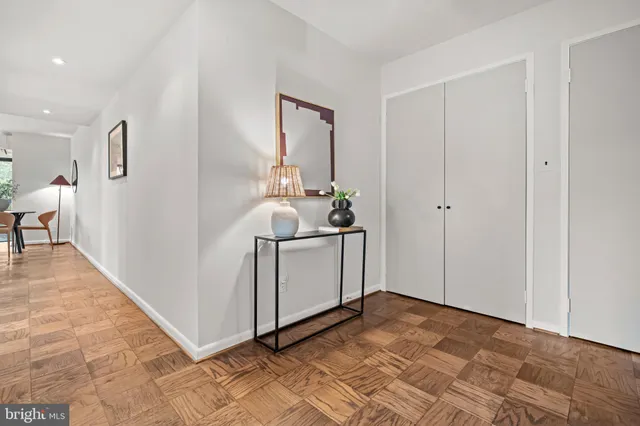 a living room with furniture and a painting on the wall