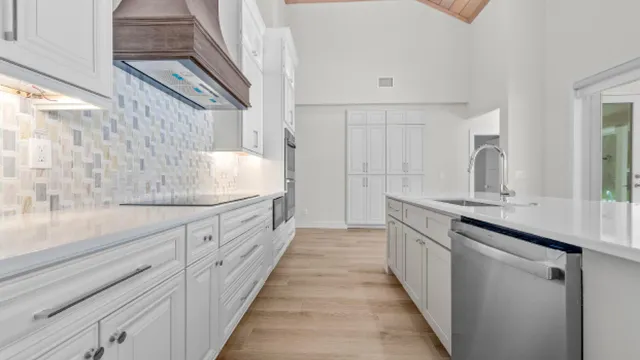 a large kitchen with a sink and cabinets