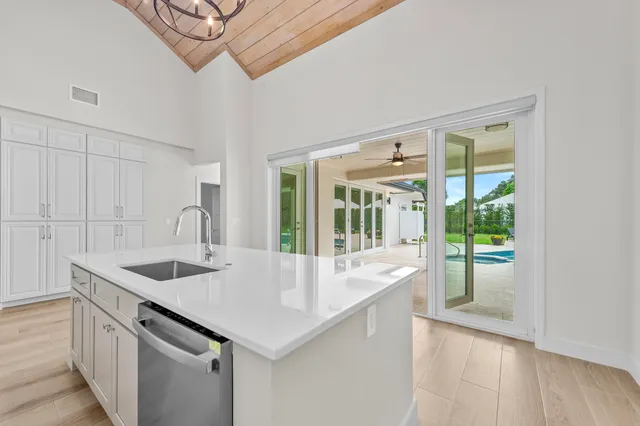 a kitchen with a sink and a large window