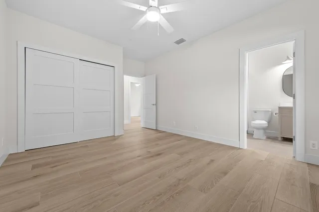 a view of a room with wooden floor and white walls