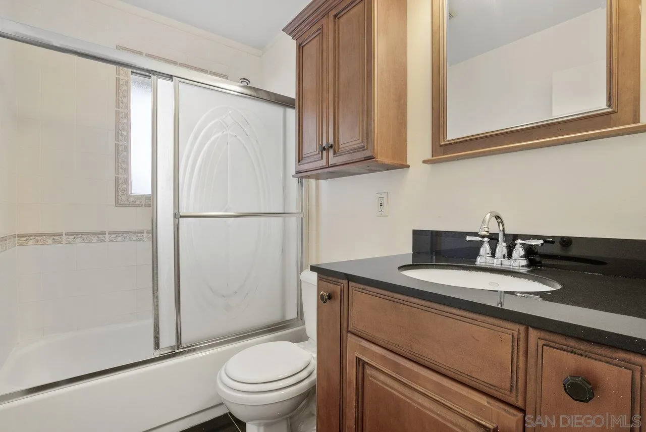 8715 Vista Del Verde El Cajon, CA 92021 - Photo 14 of 30 a bathroom with a granite countertop sink toilet and a mirror