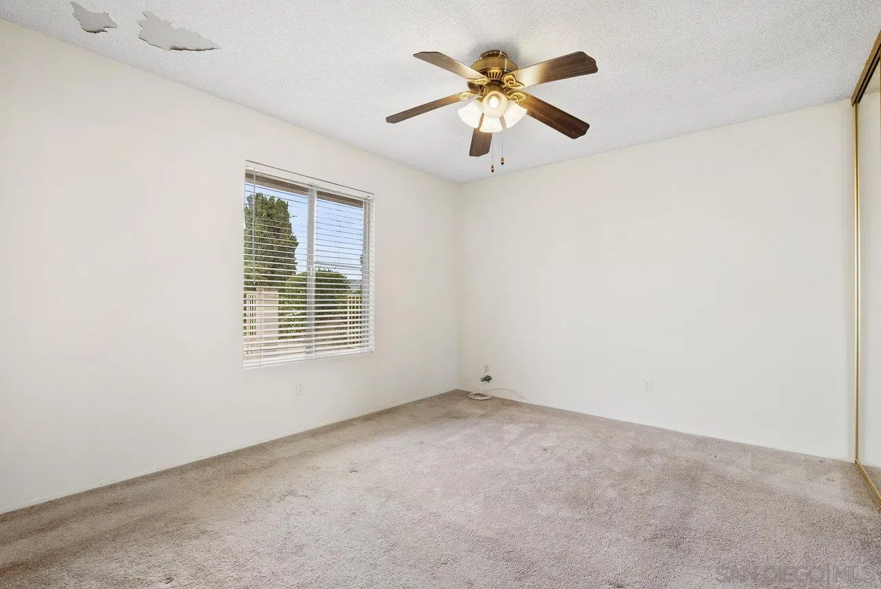 8715 Vista Del Verde El Cajon, CA 92021 - Photo 15 of 30 an empty room with a window and a fan