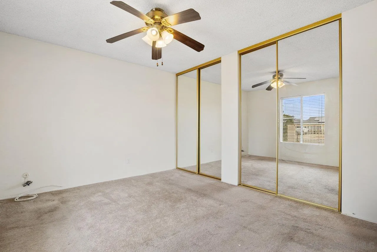 8715 Vista Del Verde El Cajon, CA 92021 - Photo 18 of 30 an empty room with fan and a chandelier fan