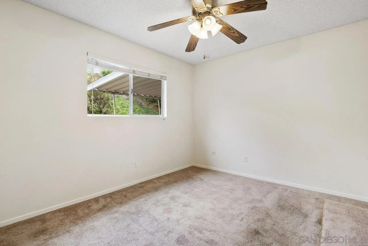 8715 Vista Del Verde El Cajon, CA 92021 - Photo 20 of 30 an empty room with a window and a fan