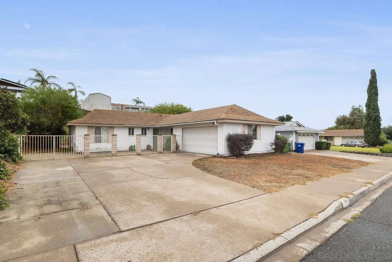 8715 Vista Del Verde El Cajon, CA 92021 - Photo 2 of 30 a front view of a house with a yard and garage