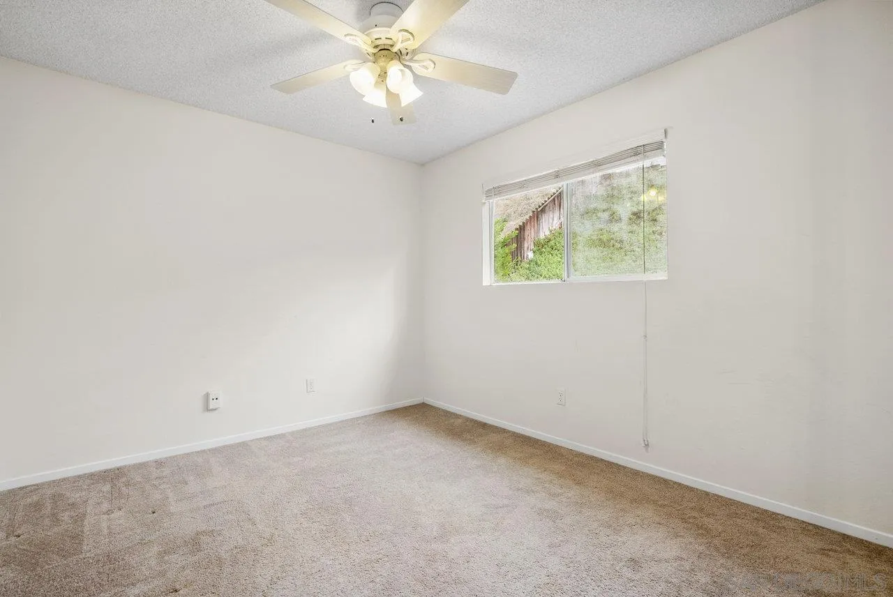 8715 Vista Del Verde El Cajon, CA 92021 - Photo 22 of 30 an empty room with a window and a fan