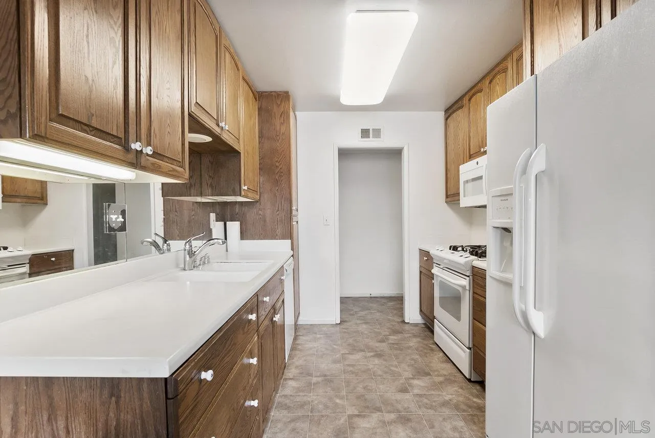 8715 Vista Del Verde El Cajon, CA 92021 - Photo 6 of 30 a kitchen with granite countertop a sink stove and refrigerator