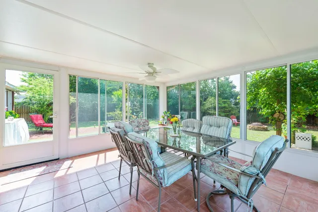 a living room with furniture and a floor to ceiling window