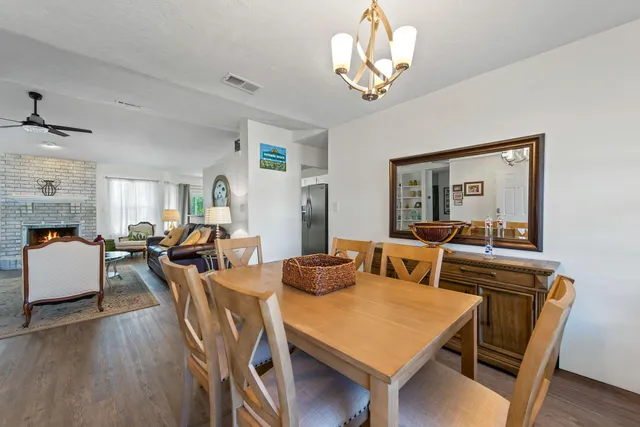 a view of a dining room with furniture wooden floor and chandelier