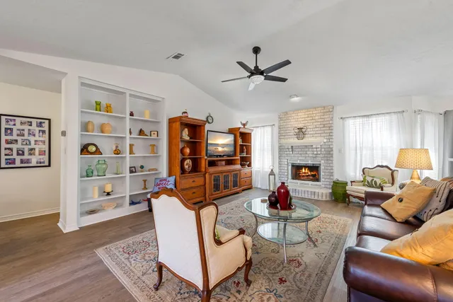 a kitchen with granite countertop a sink a stove and cabinets