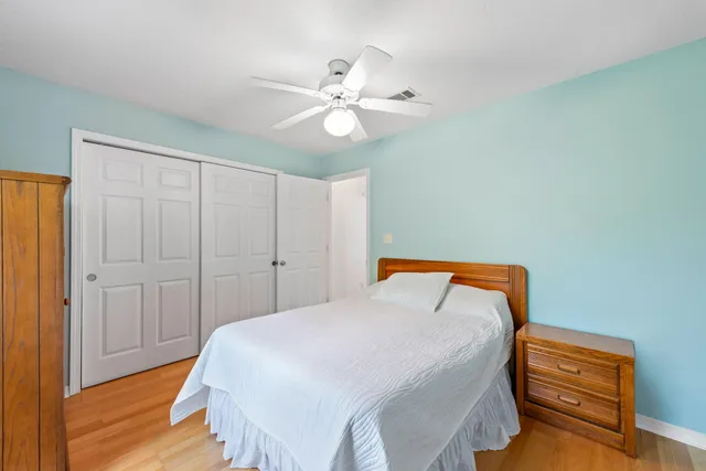 an empty room with a fan and a ceiling fan
