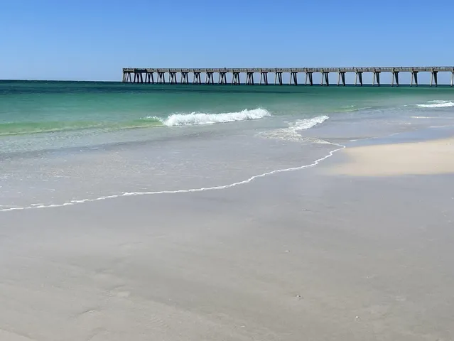 a backyard of a house with toys and wooden fence