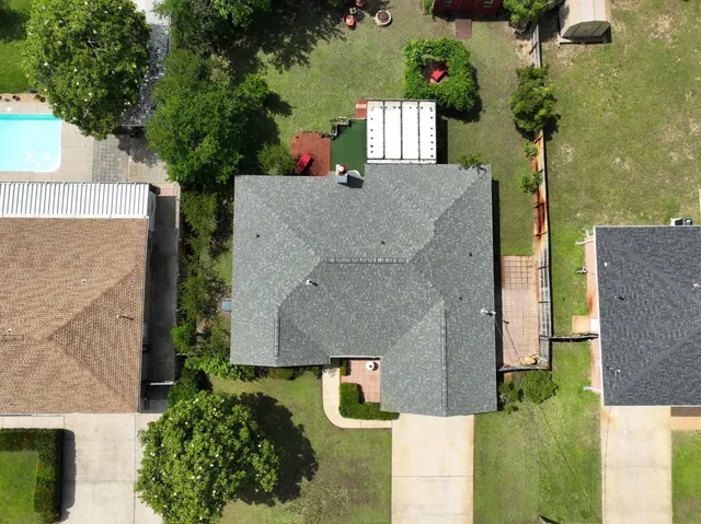a view of a backyard with a garden and trees
