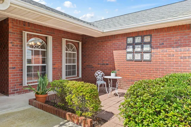 a front view of a house with outdoor seating and a potted plant