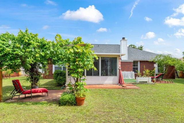 a view of a house with a yard and tree s