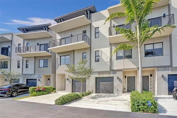 a front view of a residential apartment building with a yard