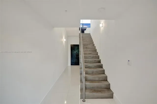 a large white kitchen with a large window