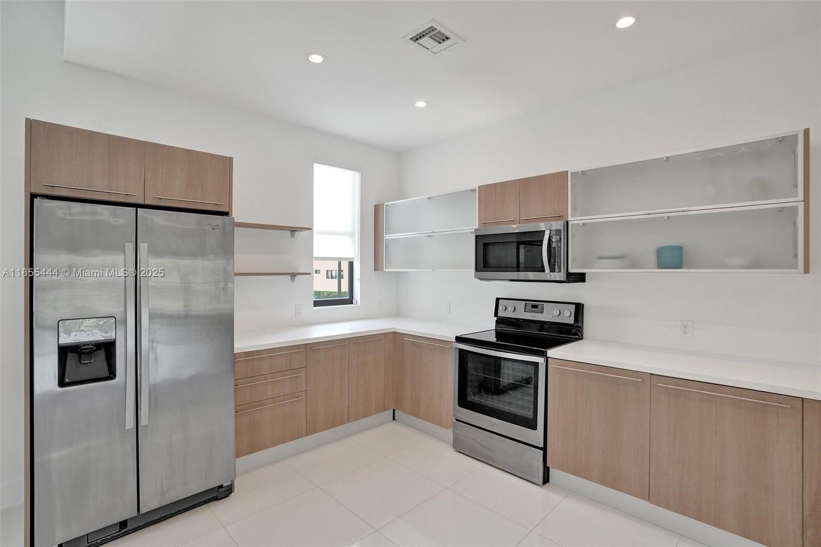 516 Southeast 1st Circle Pompano Beach, FL 33060 - Photo 14 of 81 a kitchen with stainless steel appliances granite countertop a refrigerator and a stove top oven