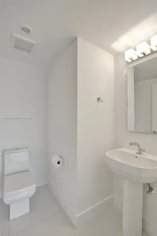a large bathroom with a large mirror vanity and a shower
