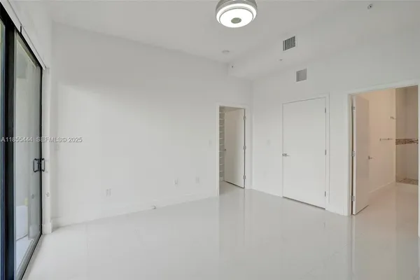 a view of a room with a fan and wooden floor
