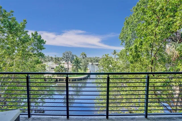a living room with patio furniture and a large window