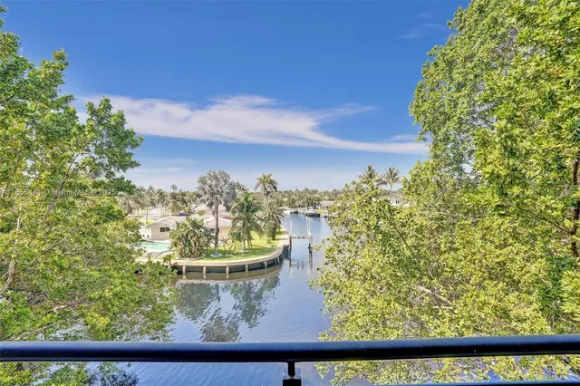 an aerial view of residential houses with outdoor space and ocean view