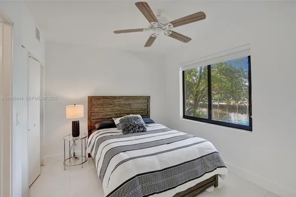 a bedroom with a bed and a window