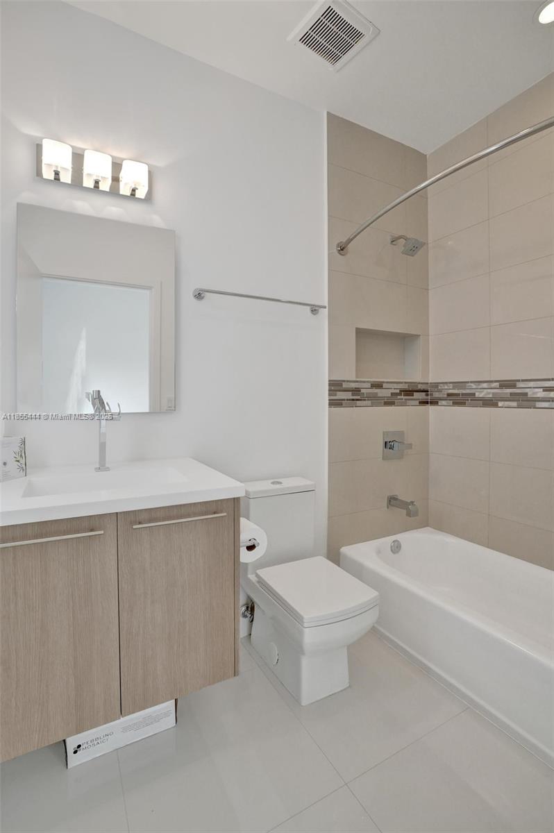 516 Southeast 1st Circle Pompano Beach, FL 33060 - Photo 59 of 81 a bathroom with a sink a toilet and shower