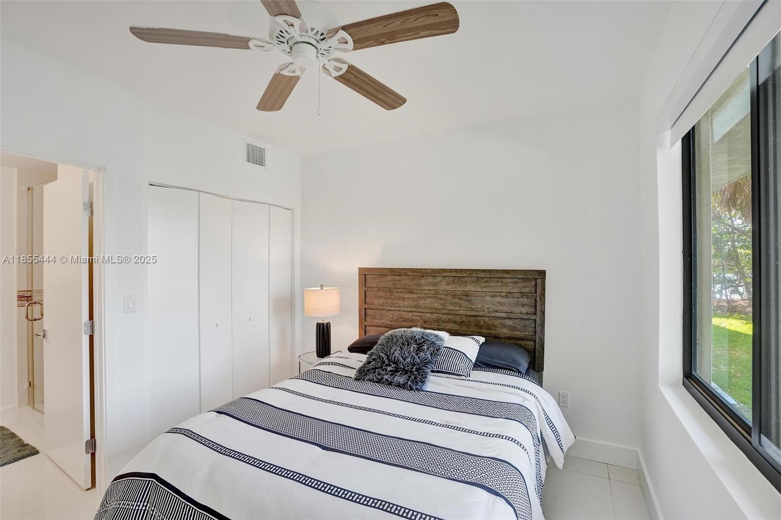 516 Southeast 1st Circle Pompano Beach, FL 33060 - Photo 6 of 81 a bedroom with a bed and a large mirror