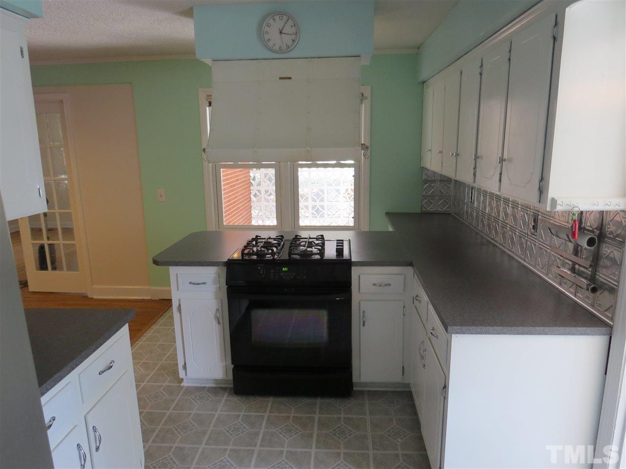 741 Colonial Drive Raleigh, NC 27603 - Photo 8 of 17 a kitchen with a sink stove and cabinets