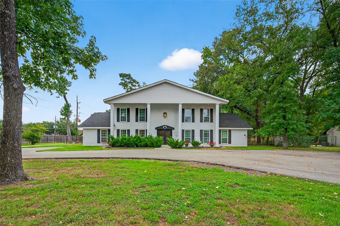 29902 East Hawthorne Drive Spring, TX 77386 - Photo 1 of 43 a front view of a house with a yard and green space