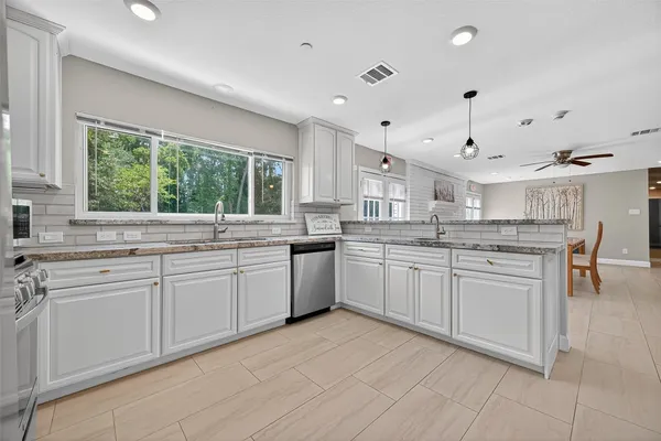 a kitchen with a sink window and cabinets
