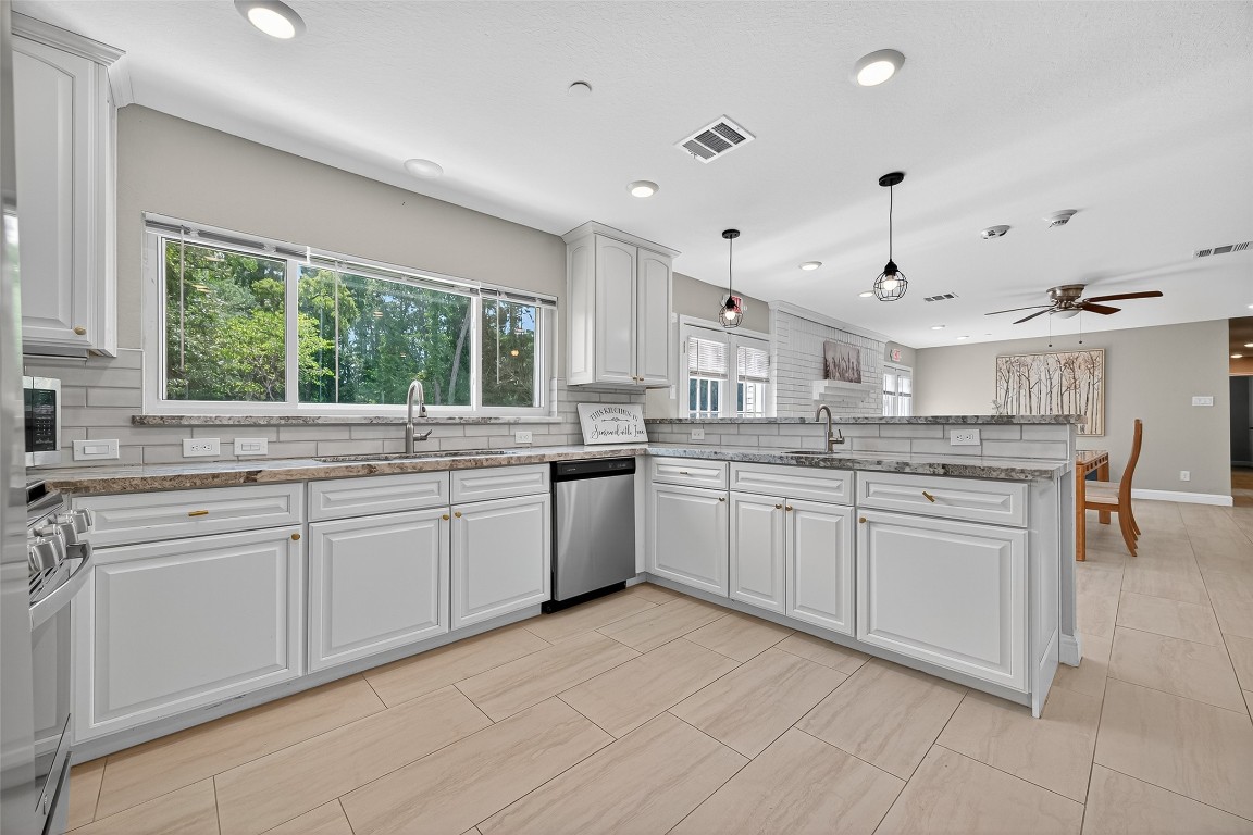 29902 East Hawthorne Drive Spring, TX 77386 - Photo 13 of 43 a kitchen with a sink window and cabinets