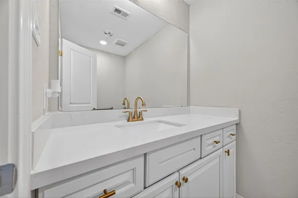 a bathroom with a sink and vanity