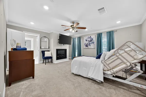 a spacious bedroom with a bed and a fireplace