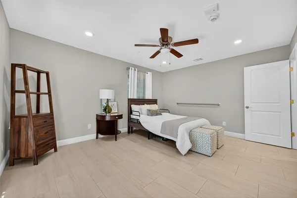 a spacious bedroom with a bed and a walk in closet