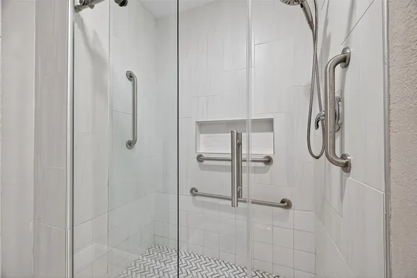 a bathroom with a glass shower door