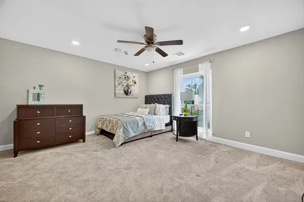 a spacious bedroom with a bed and window