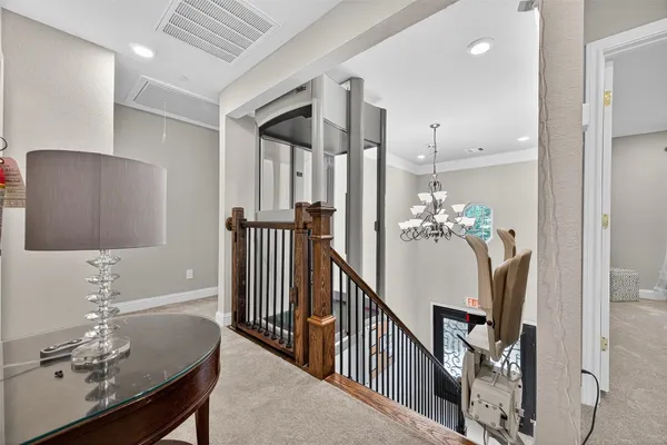 a dining room with furniture and chandelier