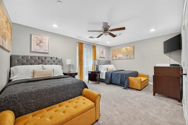 a spacious bedroom with a bed and furniture