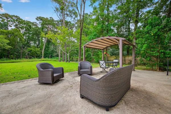 a view of a patio with a table chairs and a yard