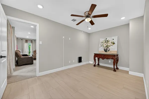 a view of a livingroom with a couch and a ceiling fan