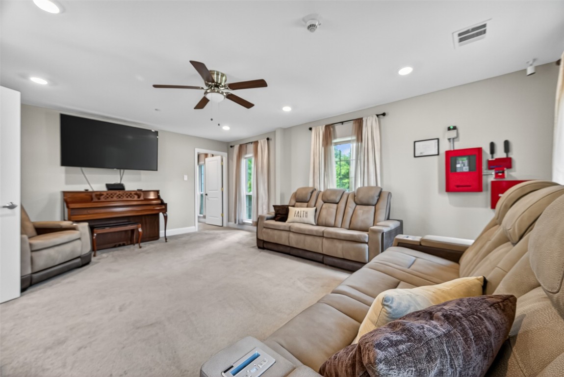 29902 East Hawthorne Drive Spring, TX 77386 - Photo 9 of 43 a living room with furniture and a flat screen tv