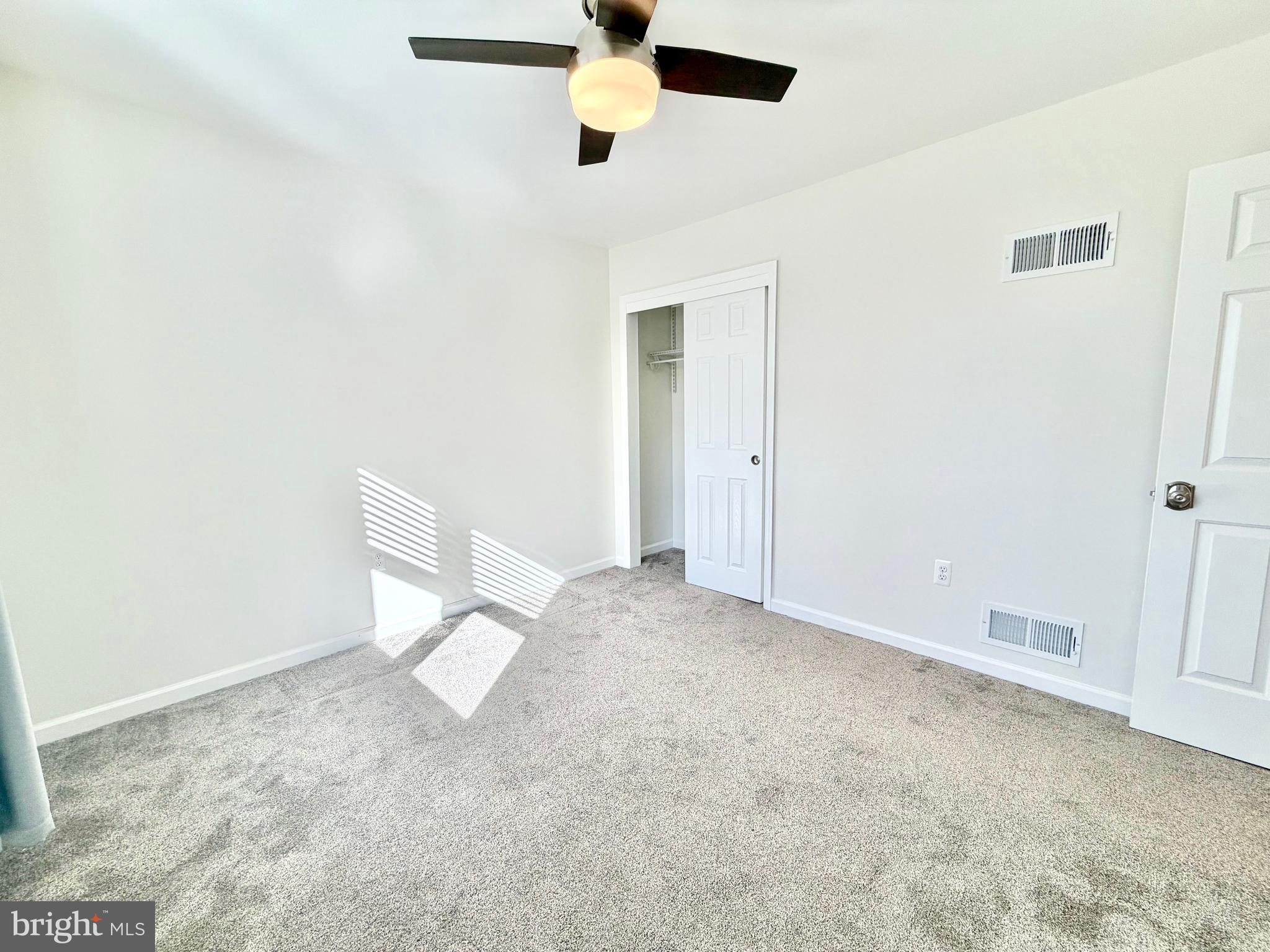 112 Chukar Court Lititz, PA 17543 - Photo 28 of 44 an empty room with a ceiling fan and carpet