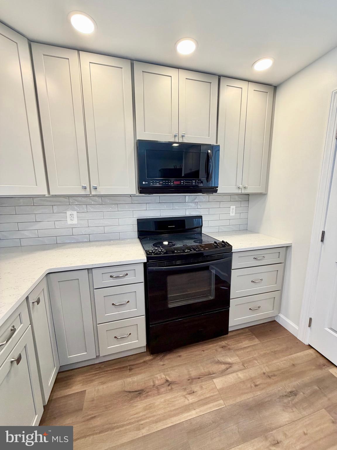 112 Chukar Court Lititz, PA 17543 - Photo 8 of 44 a kitchen with stainless steel appliances granite countertop a stove a sink and a microwave