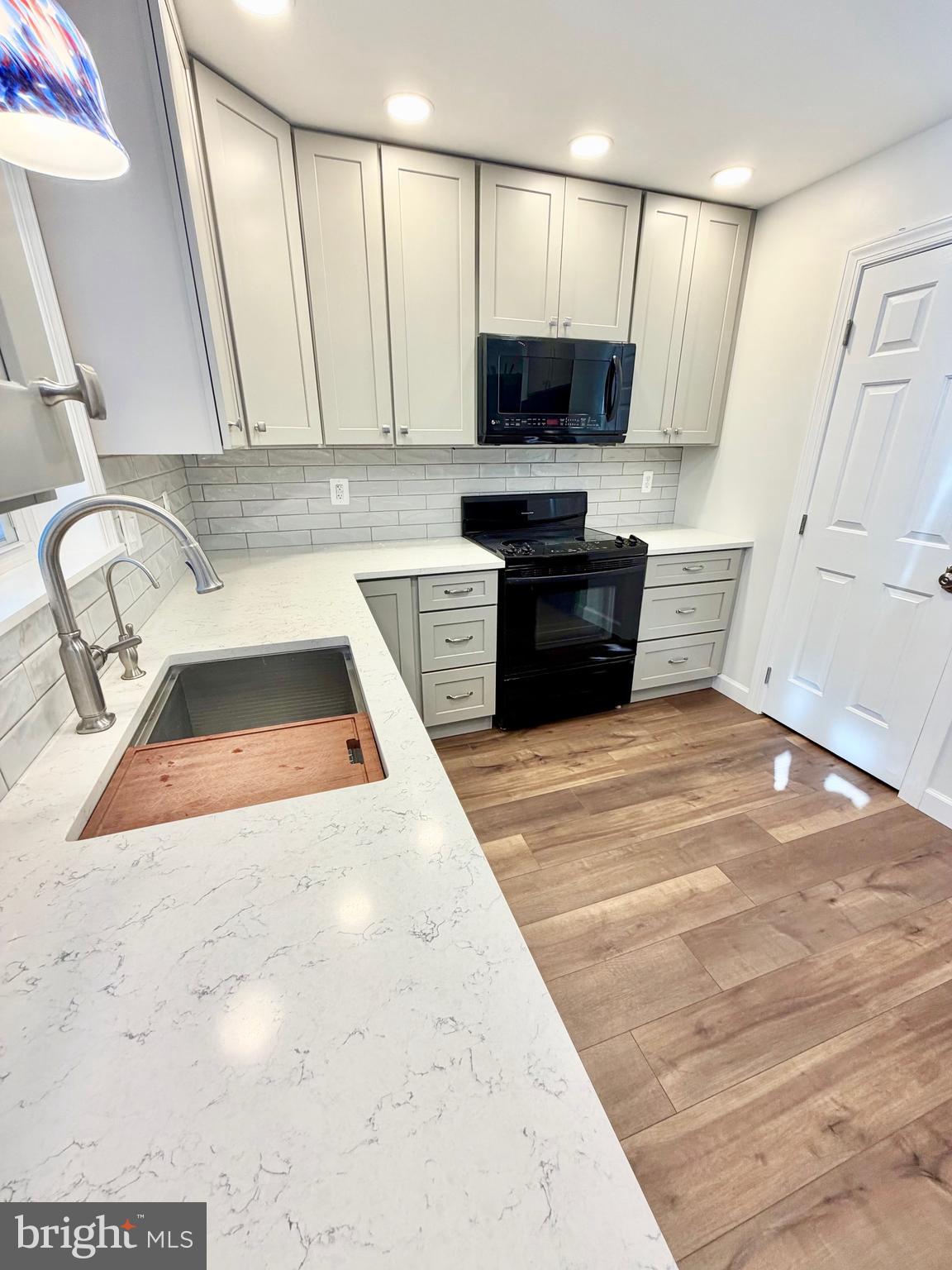 112 Chukar Court Lititz, PA 17543 - Photo 9 of 44 a kitchen with stainless steel appliances a sink a stove a microwave a sink and cabinets