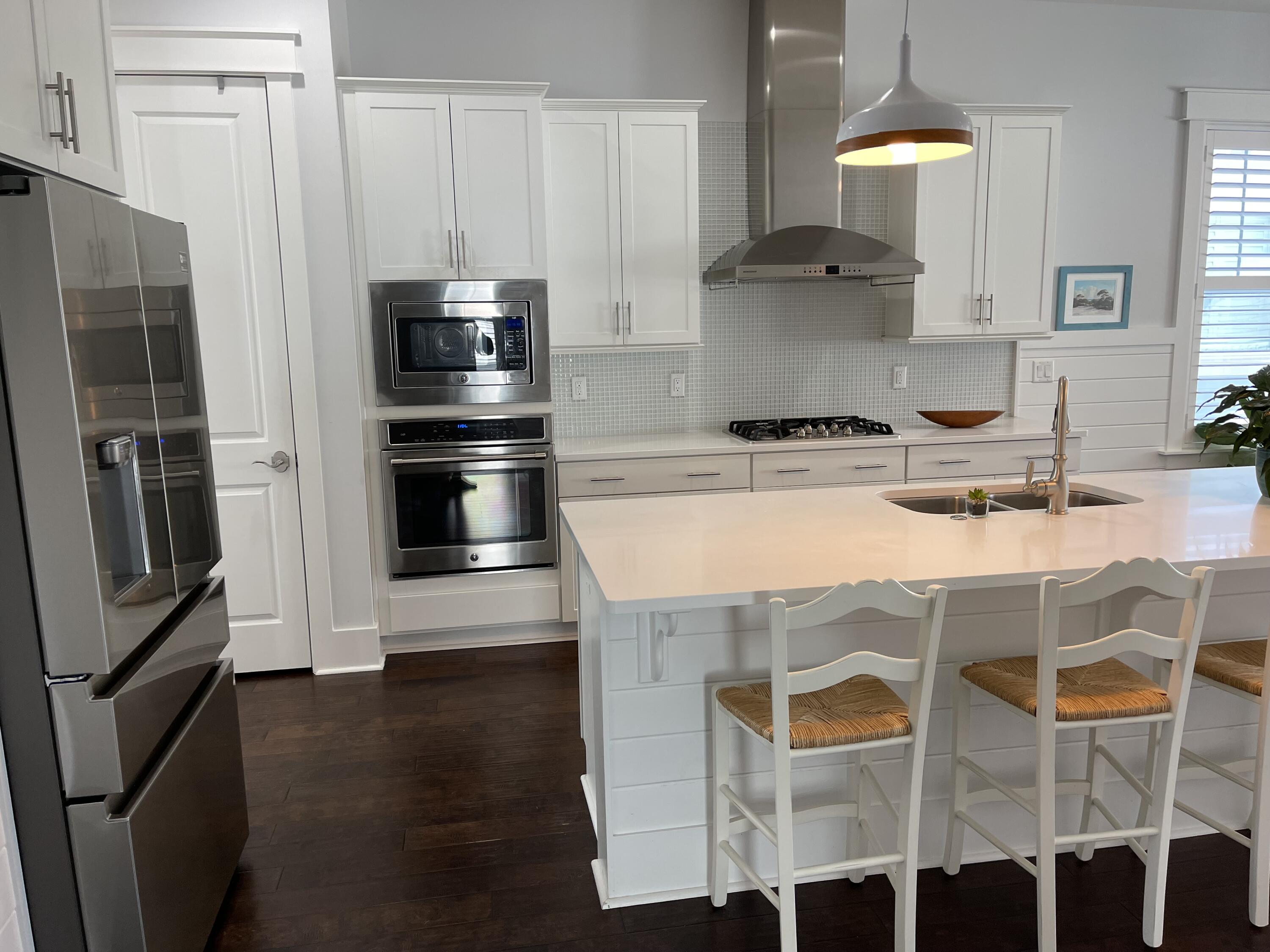 155 Flatwoods Forest Loop Santa Rosa Beach, FL 32459 - Photo 2 of 4 a kitchen with stainless steel appliances granite countertop a stove and a refrigerator