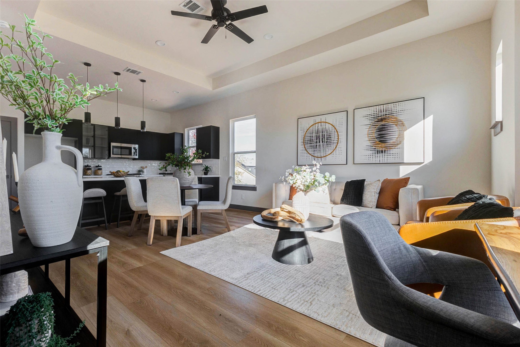 4803 Paula Street Houston, TX 77033 - Photo 11 of 28 Chic open-concept living space with abundant natural light, presenting a cozy dining area and a comfortable lounge for contemporary living.