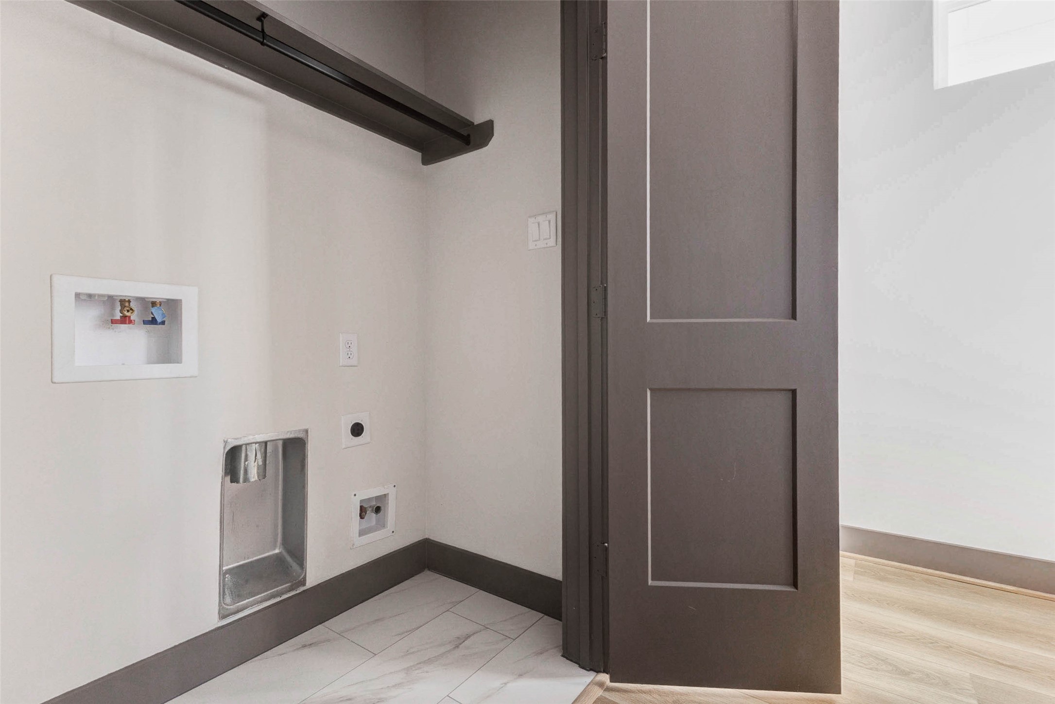 4803 Paula Street Houston, TX 77033 - Photo 20 of 28 The full size laundry area has electric and gas hookups for the dryer in addition to the washer hookups, and a shelf above for extra storage.