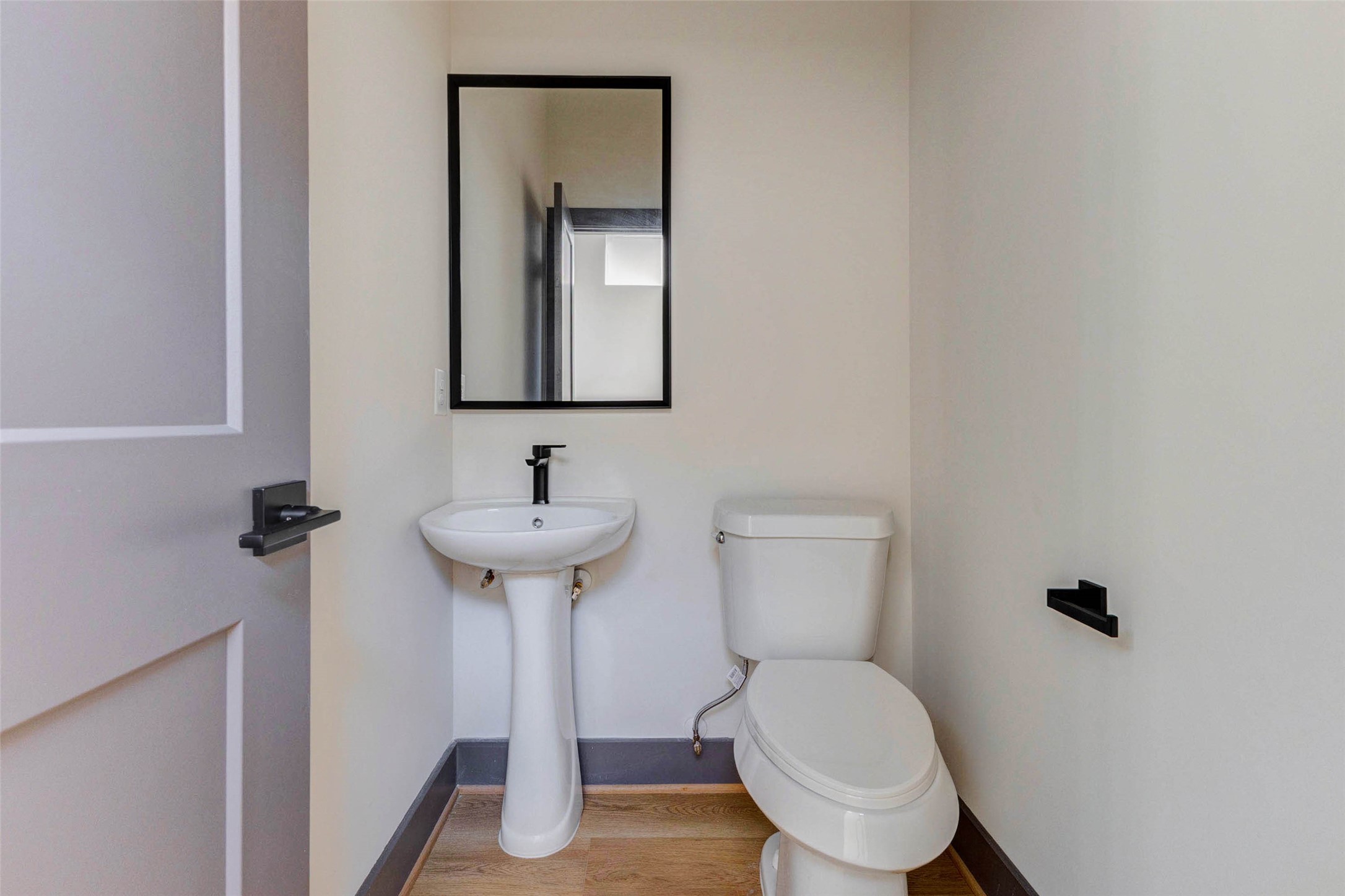 4803 Paula Street Houston, TX 77033 - Photo 21 of 28 The powder room is conveniently located in the hallway off the kitchen/living area.